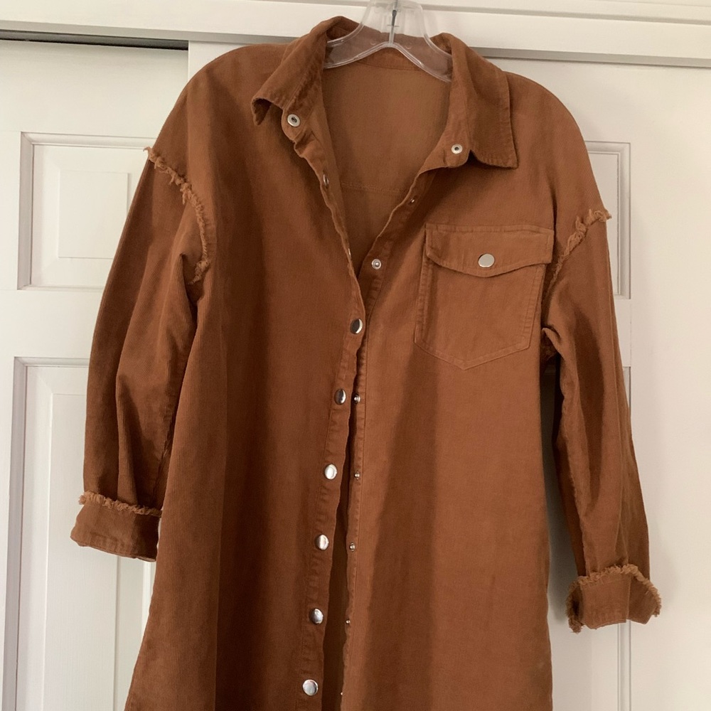 Long sleeve, lightweight button down, jacket in a rich brown/cinnamon color